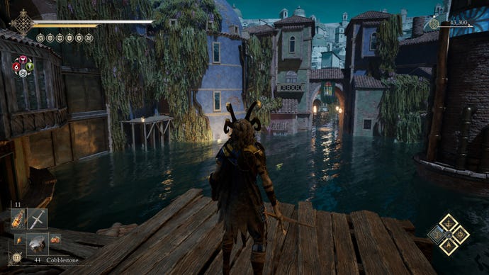 Standing on a wooden platform overlooking a flooded town.