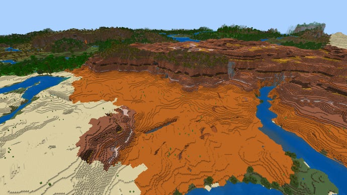 Screenshot of a top-down view of a Badlands biome in Minecraft Bedrock, with the entrance to a ravine in the foreground below.