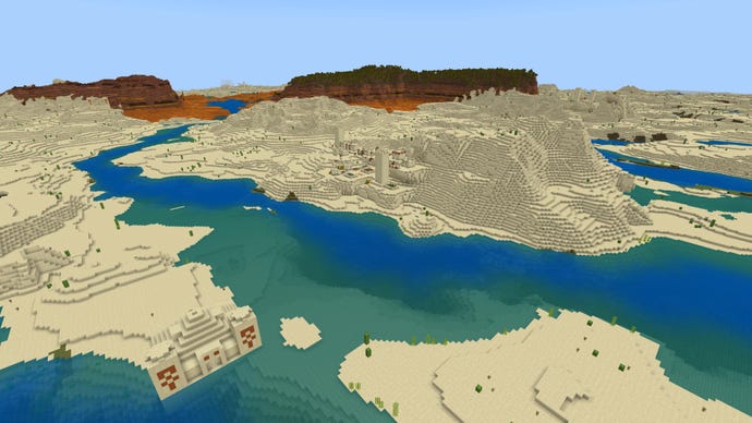 Screenshot of a Minecraft Bedrock landscape with desert and river in the foreground and badlands in the distance.