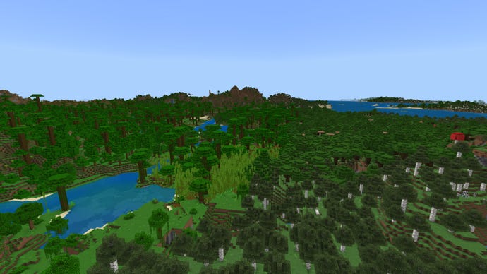 Screenshot of a forest-covered Minecraft Bedrock landscape, with Jungle on the left, birch forest on the right, and mountains in the background.